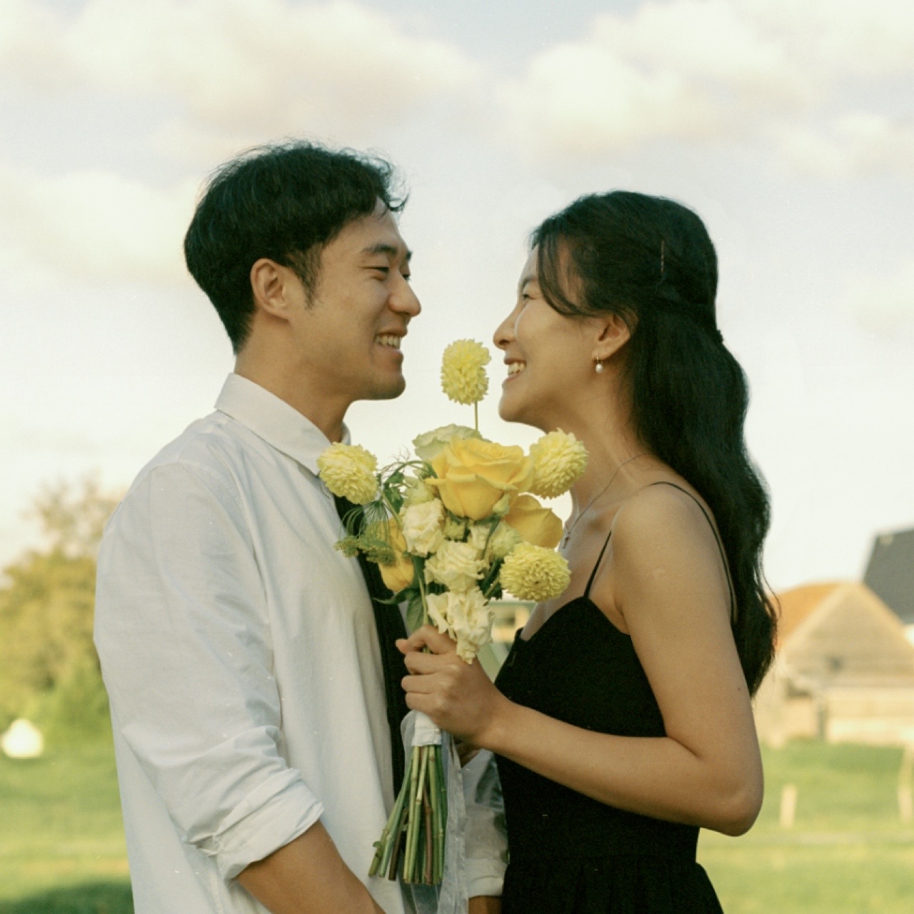 Smiling face to face with yellow flowers