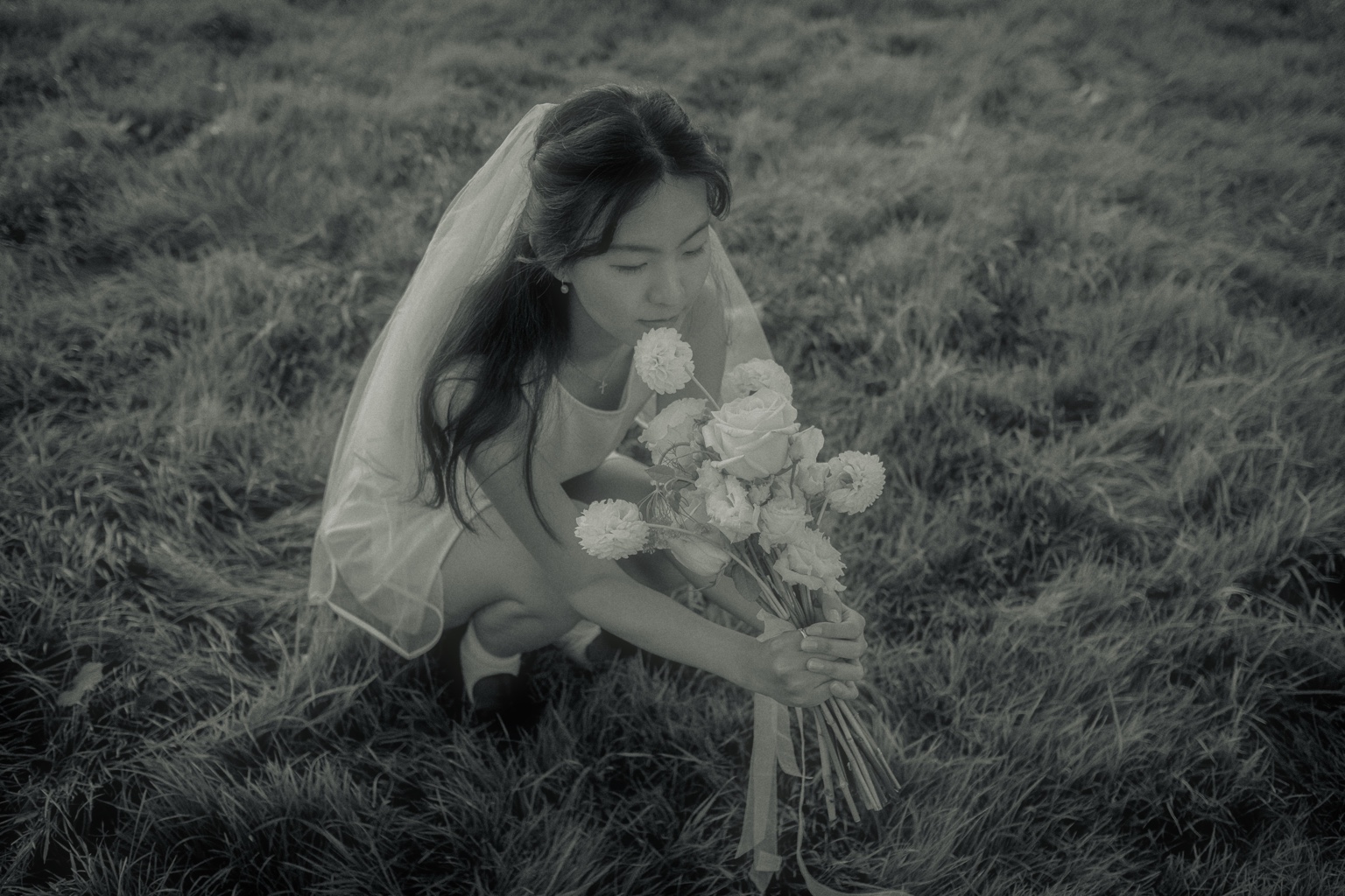 Hoyeon with her bouquet in the grass